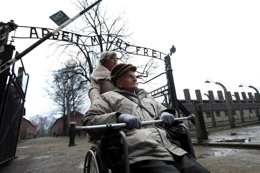 Woman pushing an elderly man's wheelchair