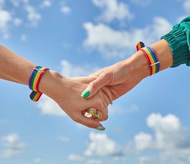 people holding hands rainbow elements and clouds